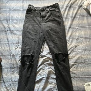 No Boundaries size 7 straight leg black jeans with holes at knees.